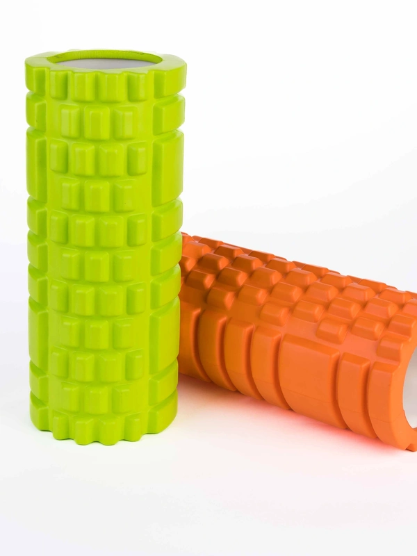 Green and orange textured foam rollers for muscle massage and exercise.