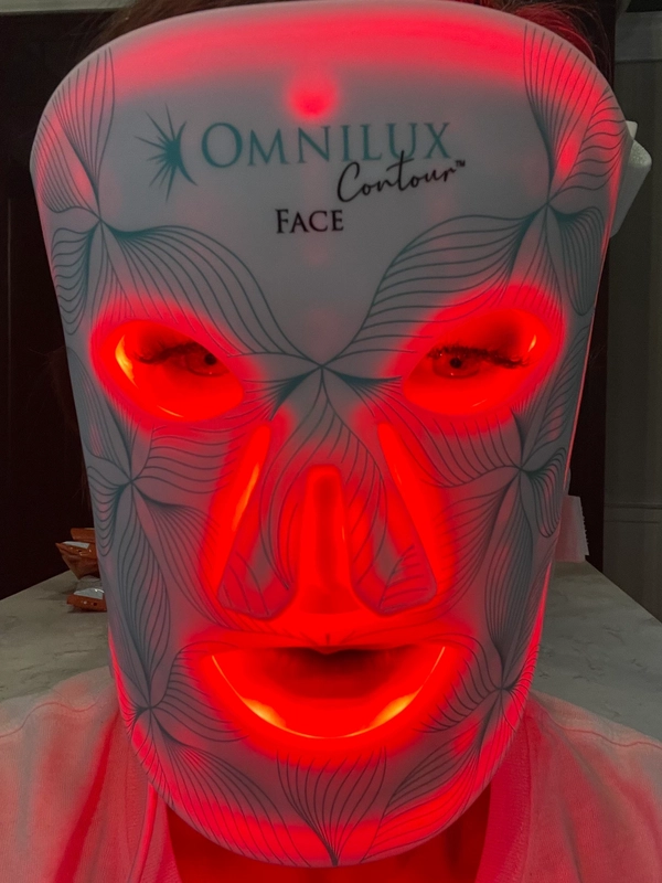 Glowing red facial mask with illuminated eyes and mouth.