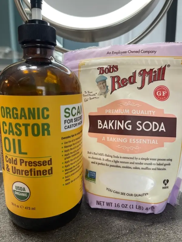 A bottle of organic castor oil and a package of baking soda.
