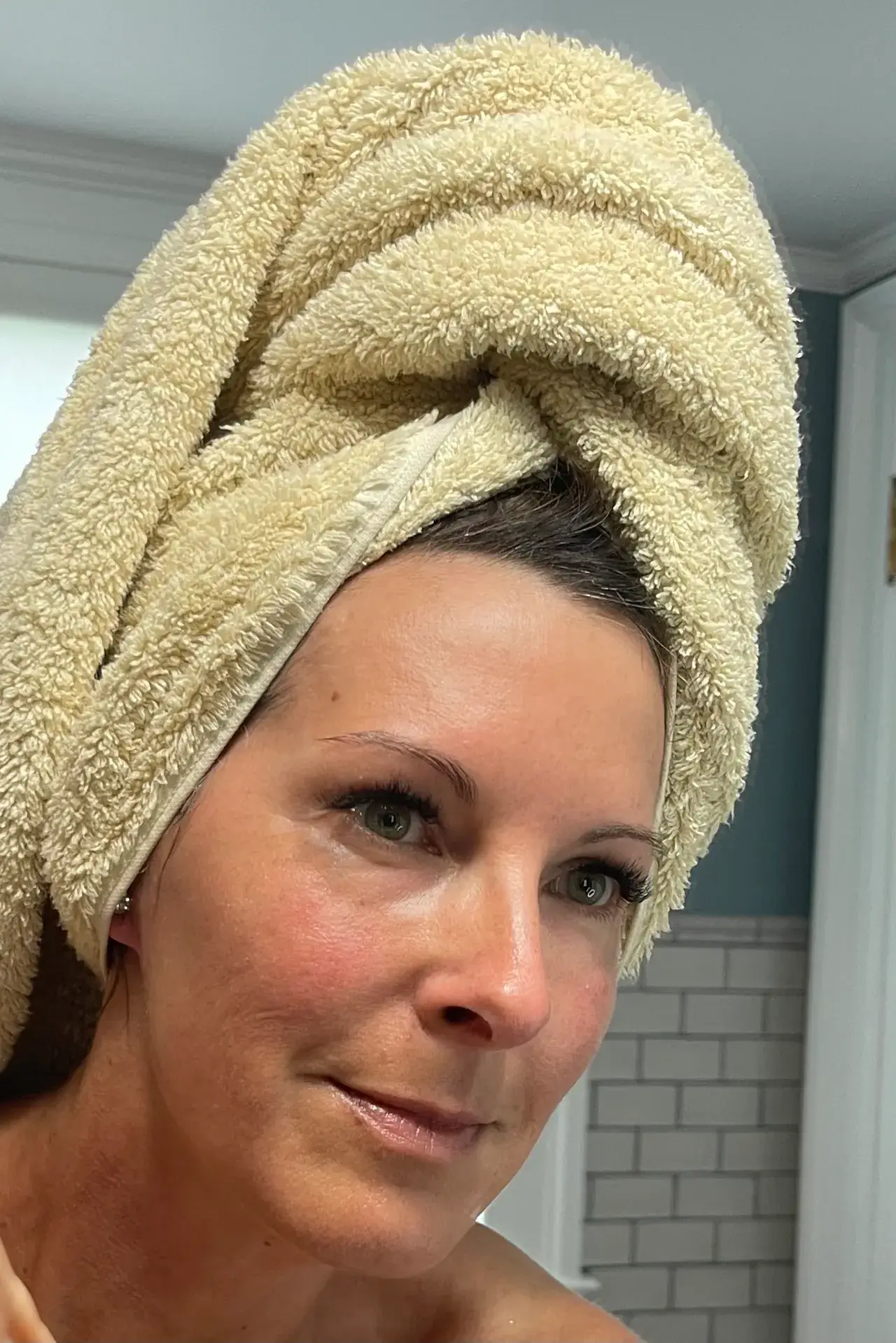 Woman with a towel wrapped around her head after a shower.