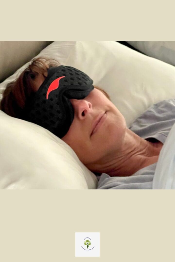 Woman resting in bed wearing a sleep mask, representing nighttime rest and midlife sleep support.