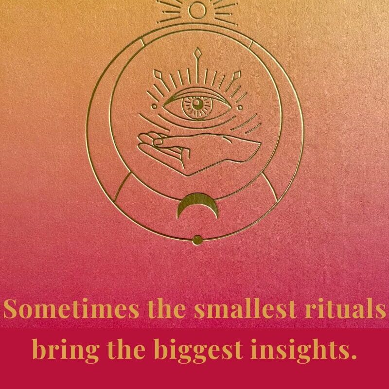 Close-up of a gradient pink and gold journal embossed with a hand and eye symbol, representing reflection, mindfulness, and personal insight — the journaling practice featured in My Midlife Mix.