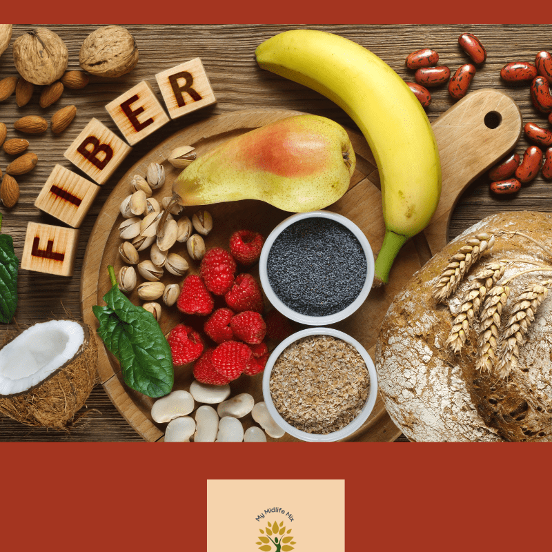 High-fiber foods including bananas, pears, raspberries, oats, nuts, and seeds on a wooden board with the word FIBER spelled in blocks. Text overlay: How much do we really need?