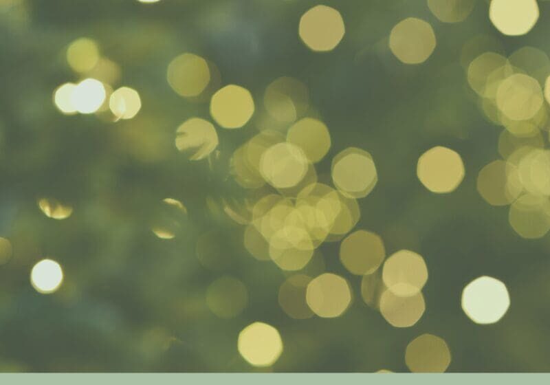 Soft green and gold bokeh holiday lights with the text “Choosing Calm in a Busy Season,” representing finding peace during the holidays.