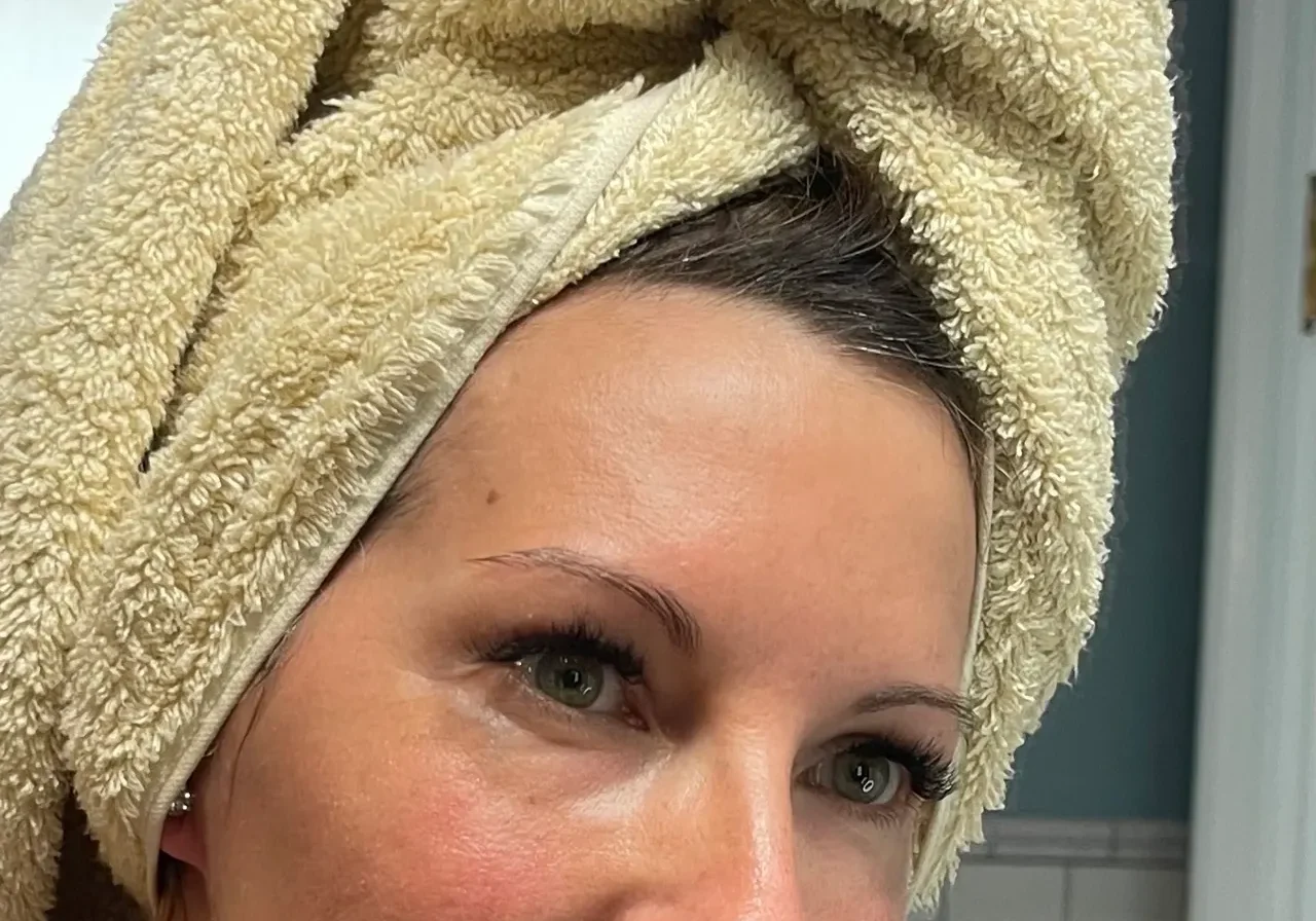 Woman with a towel wrapped around her head after a shower.