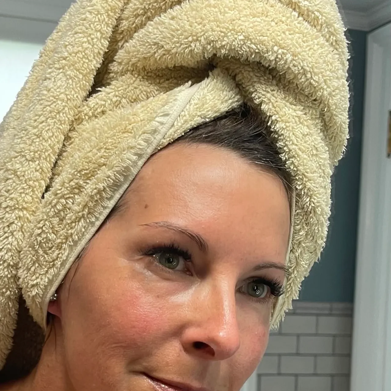 Woman with a towel wrapped around her head after a shower.